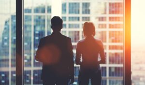 two people in an office looking out of a window