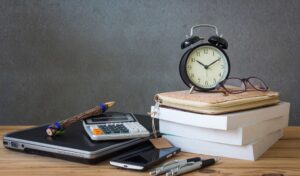 Desk, alarm clock, calculator, pens